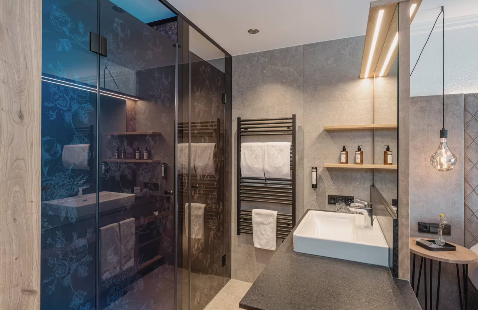 Bathroom featuring walk-in glass shower and heated towel rack