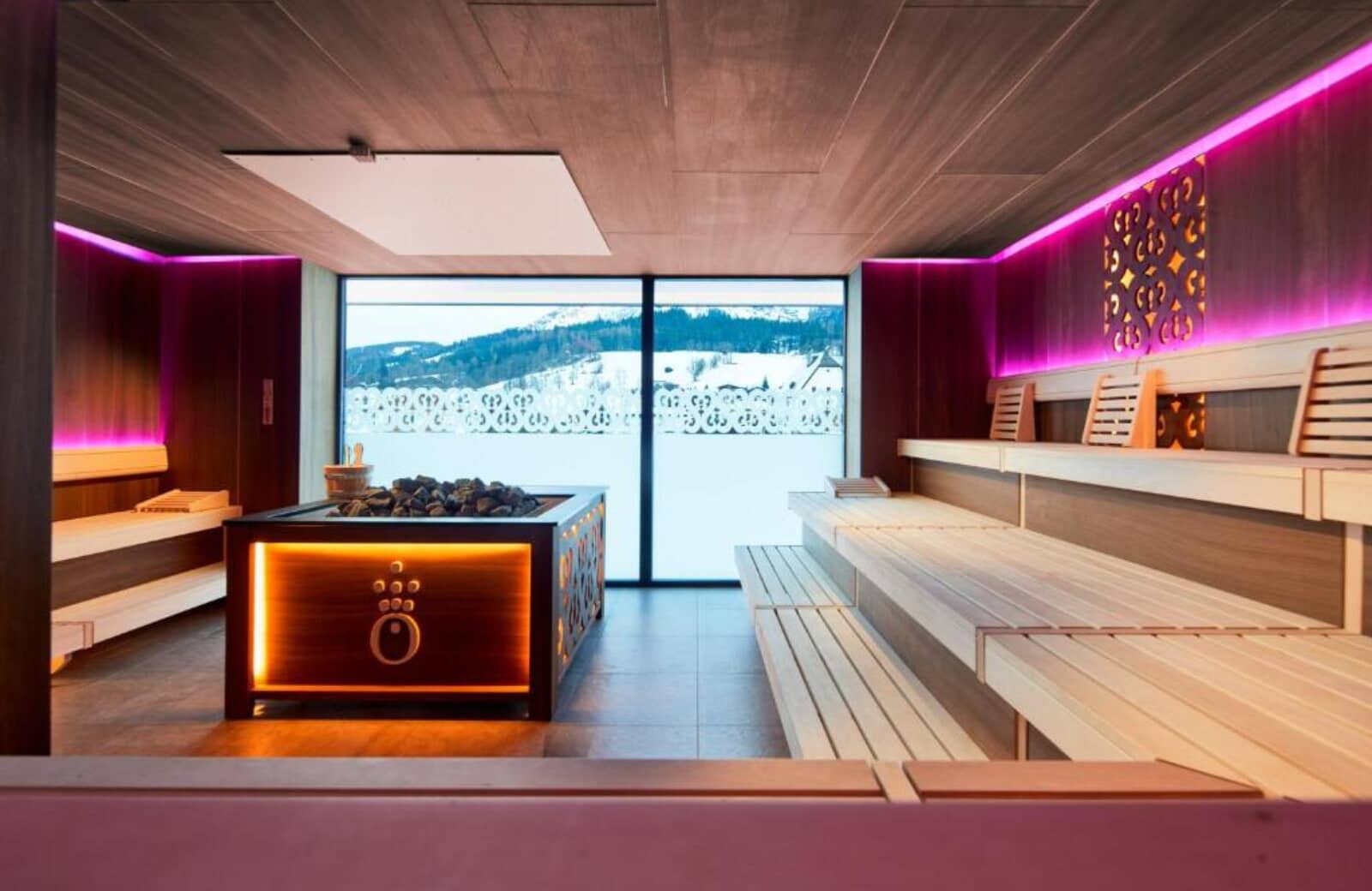 Private sauna with tiered seating and floor-to-ceiling mountain views