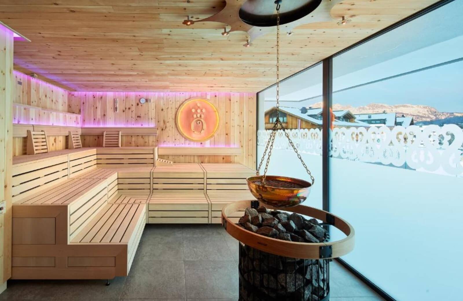 Finnish sauna with tiered seating and panoramic mountain views