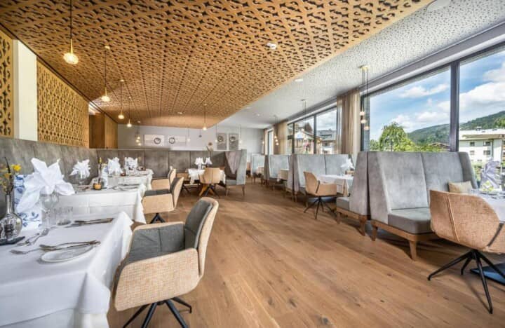 Dining room with booth seating and floor-to-ceiling mountain views