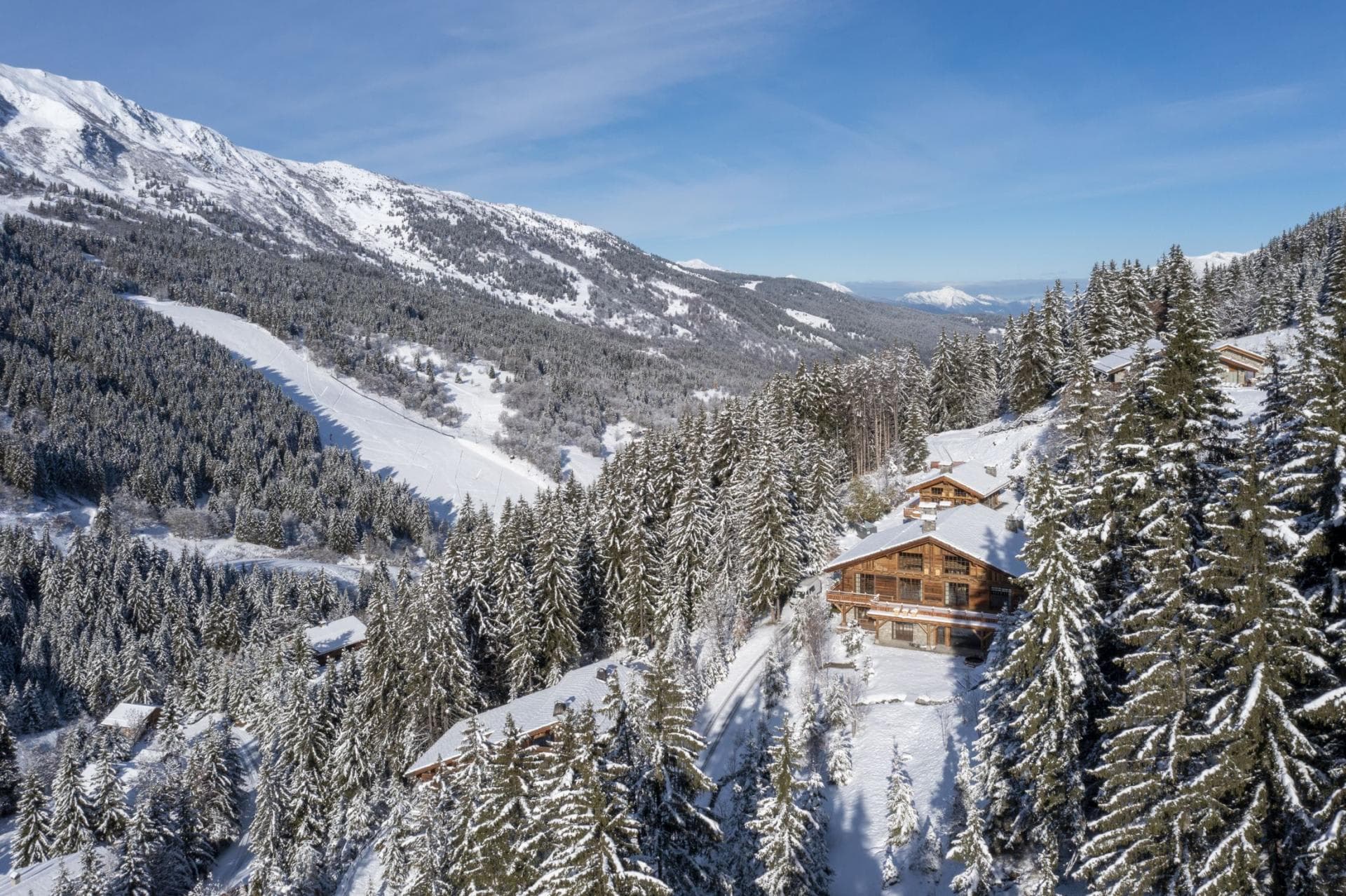 Aerial view of alpine chalet with direct ski-in/ski-out access and mountain views
