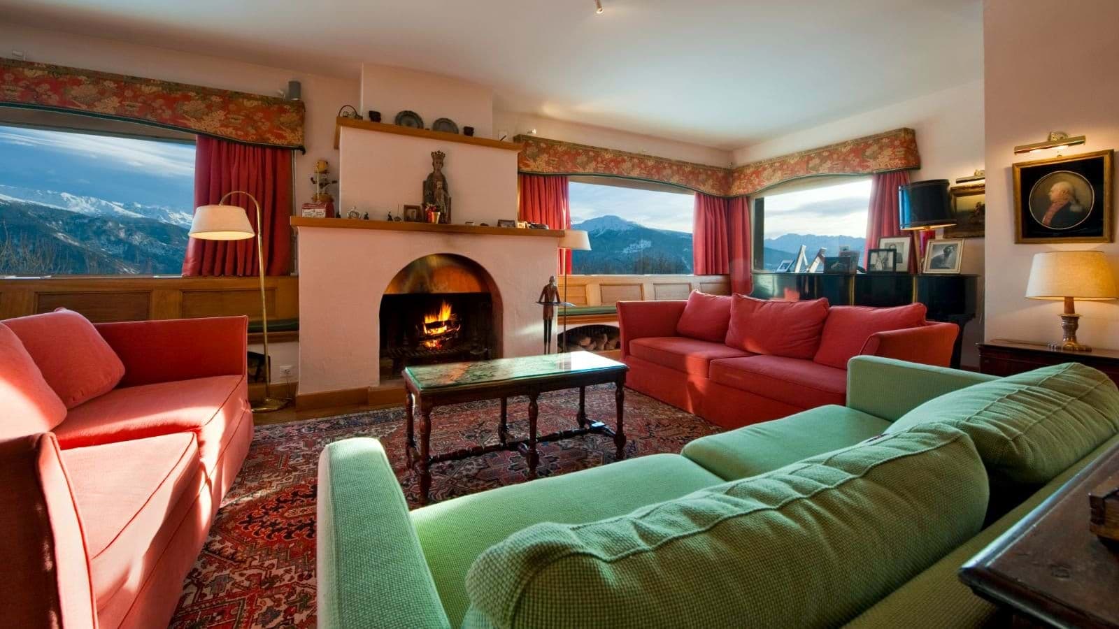 Living area with wood-burning fireplace and mountain-view picture windows