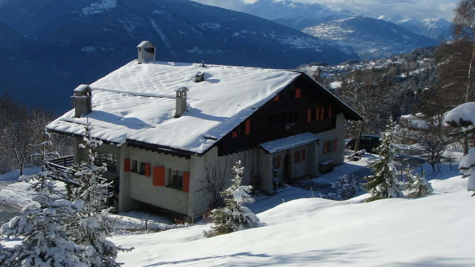 Chalet exterior with mountain valley views and private driveway access