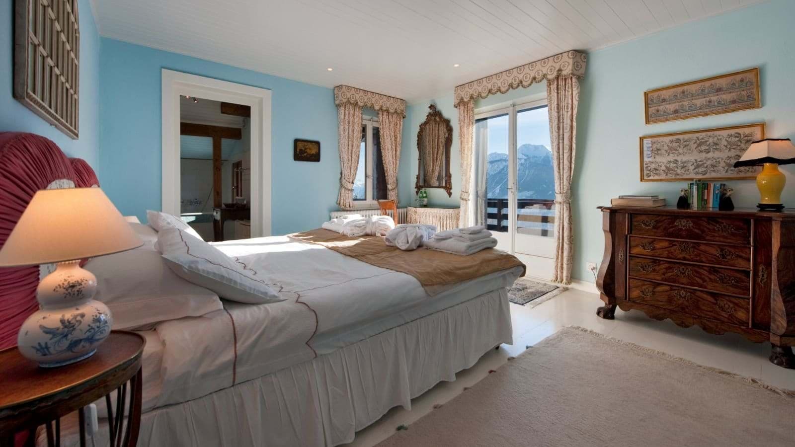 Primary bedroom with balcony access and mountain views