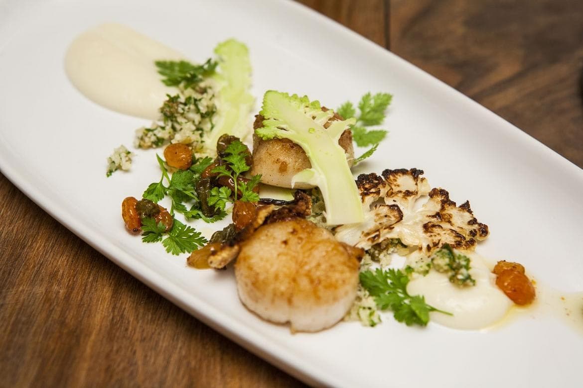 Plated gourmet meal; private chef services available for in-home dining