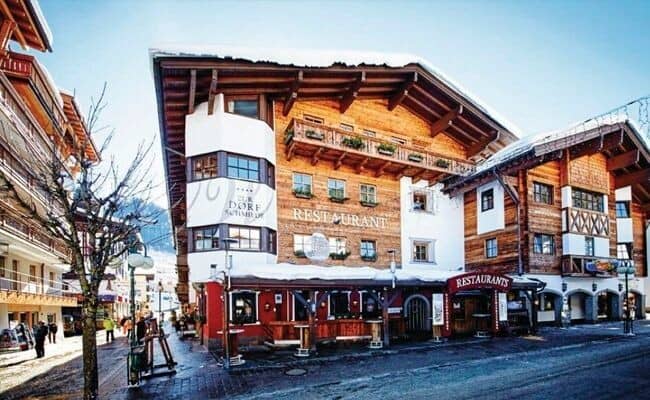 Chalet exterior with ground-floor restaurant and private balconies