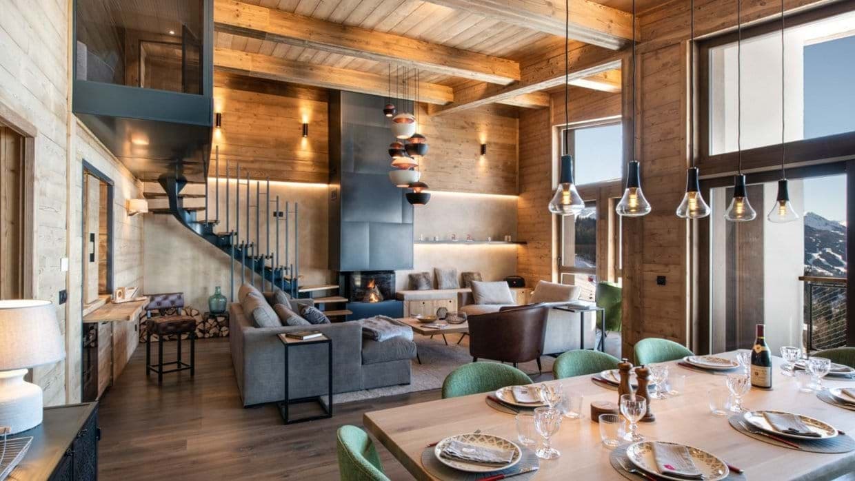 Open-plan living area with wood-burning fireplace and mezzanine loft