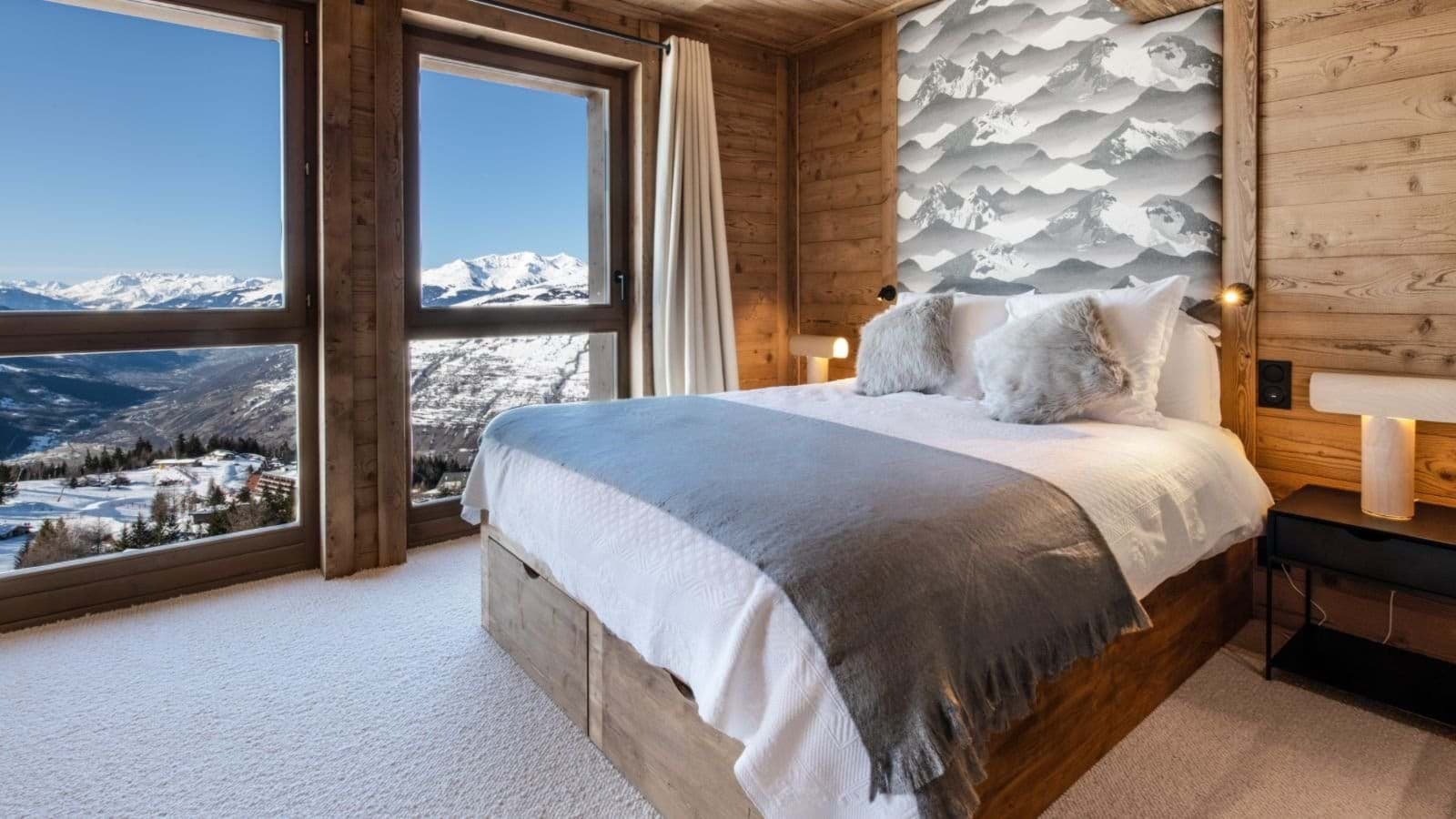 Bedroom with queen bed, under-bed storage, and panoramic mountain views