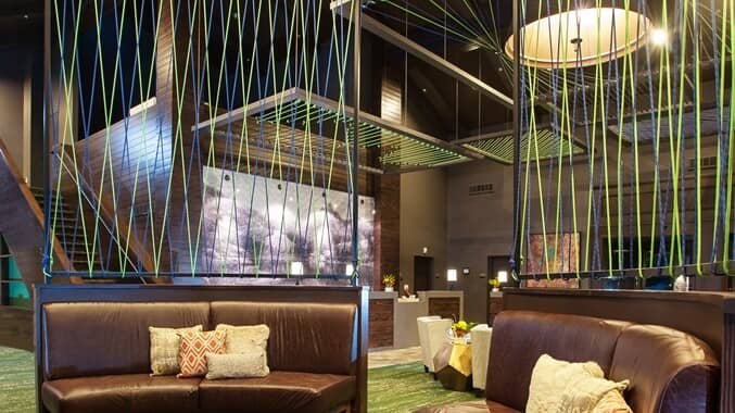 Lobby lounge with leather banquette seating and reception desk in background