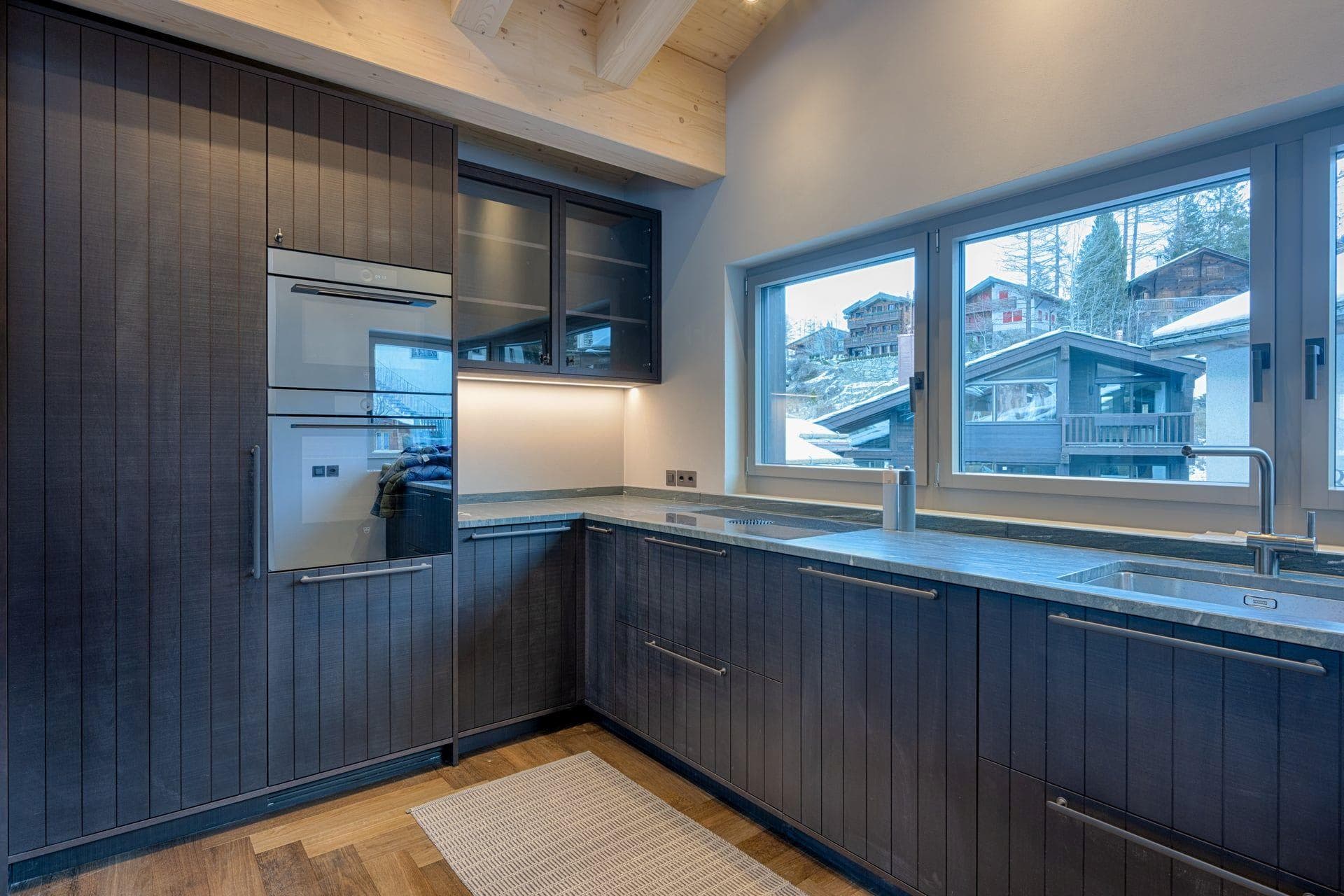 Kitchen with Miele double wall ovens and village views