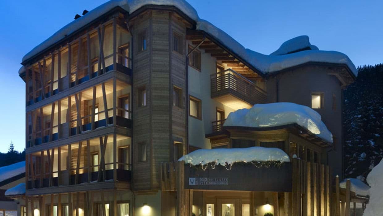 Ski-in chalet exterior with private balconies and timber architecture