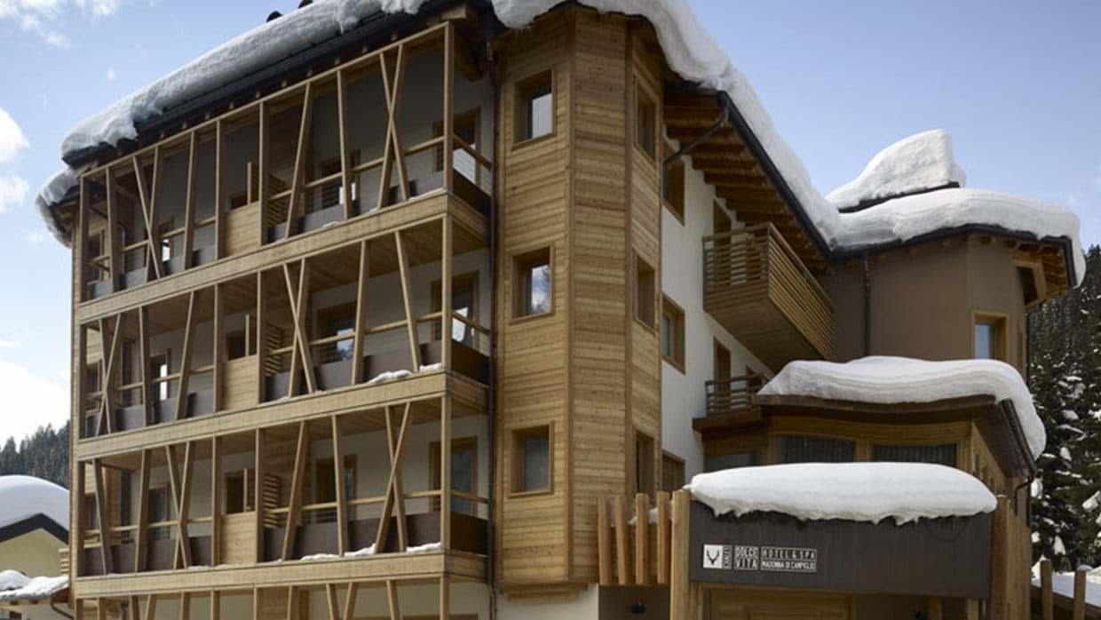 Chalet exterior featuring private timber balconies and snow-covered roof