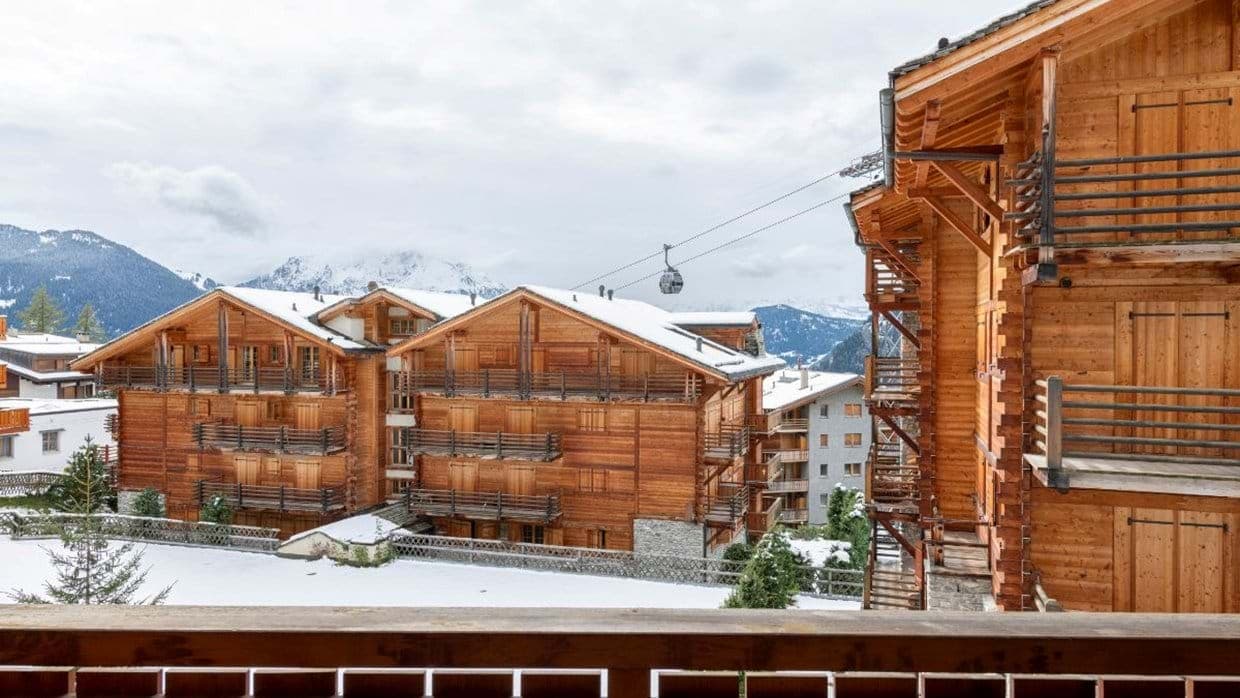 Balcony view of neighboring chalets and local gondola lift