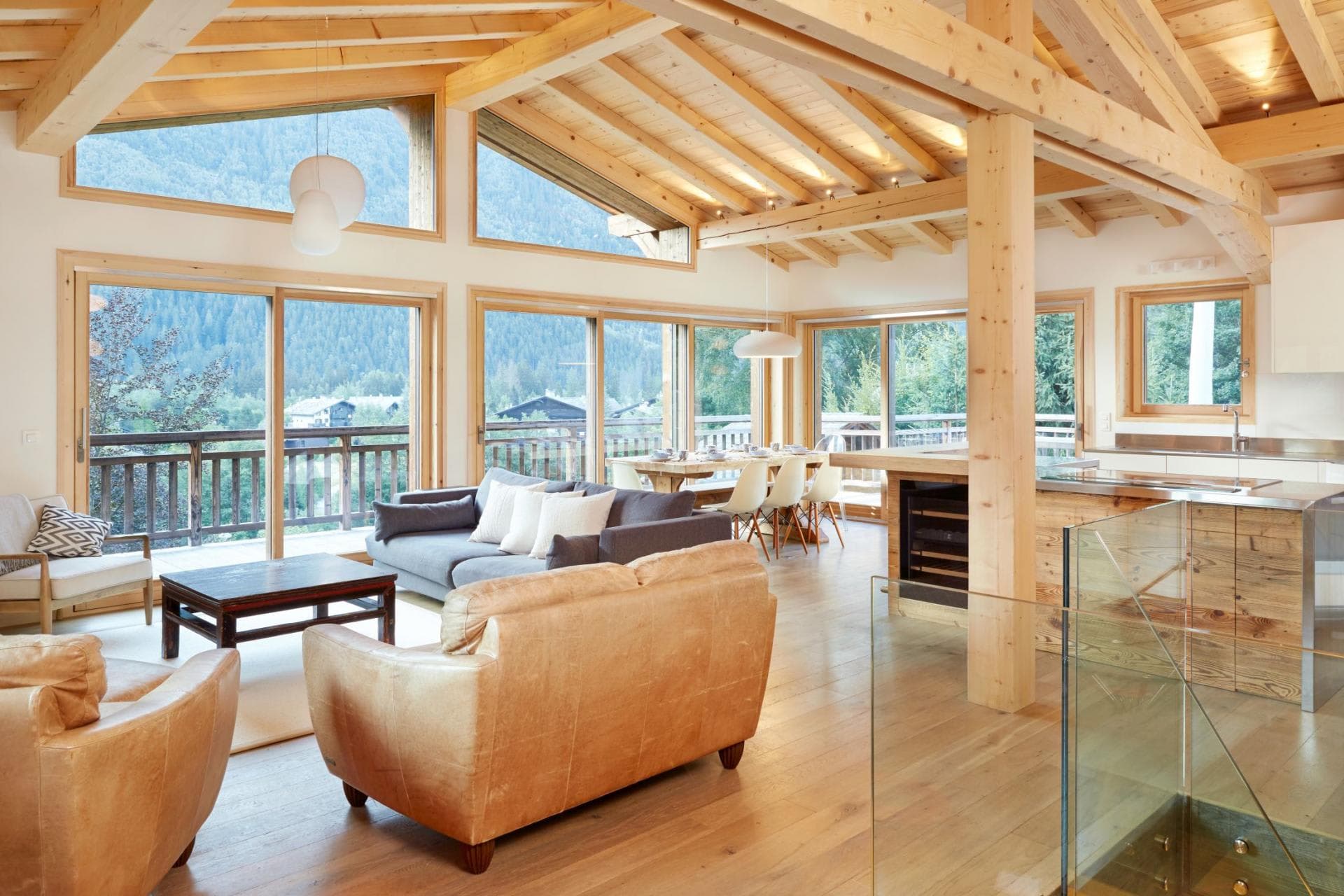 Open-plan living area with vaulted timber ceilings and mountain views