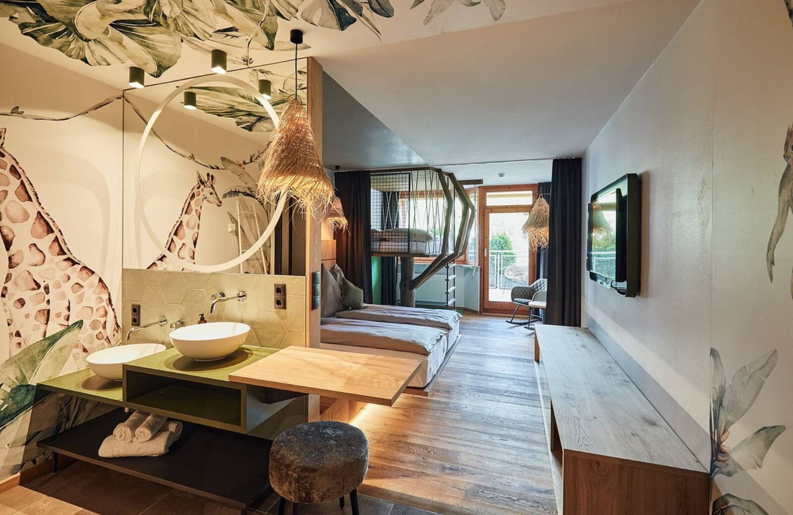 Family suite with twin beds, lofted bunk, and open vanity