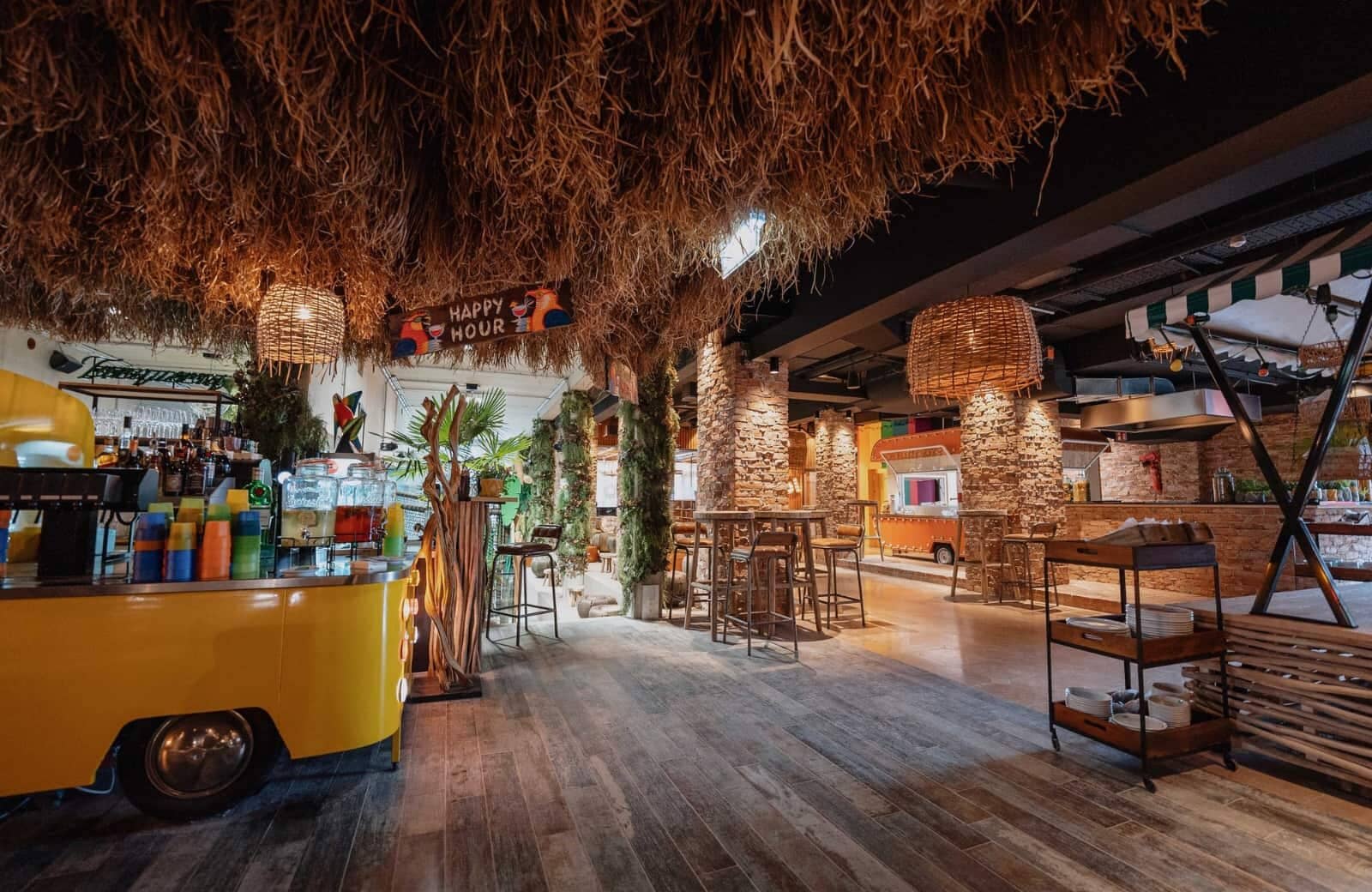 On-site bar and social lounge with thatched ceiling and food truck stations