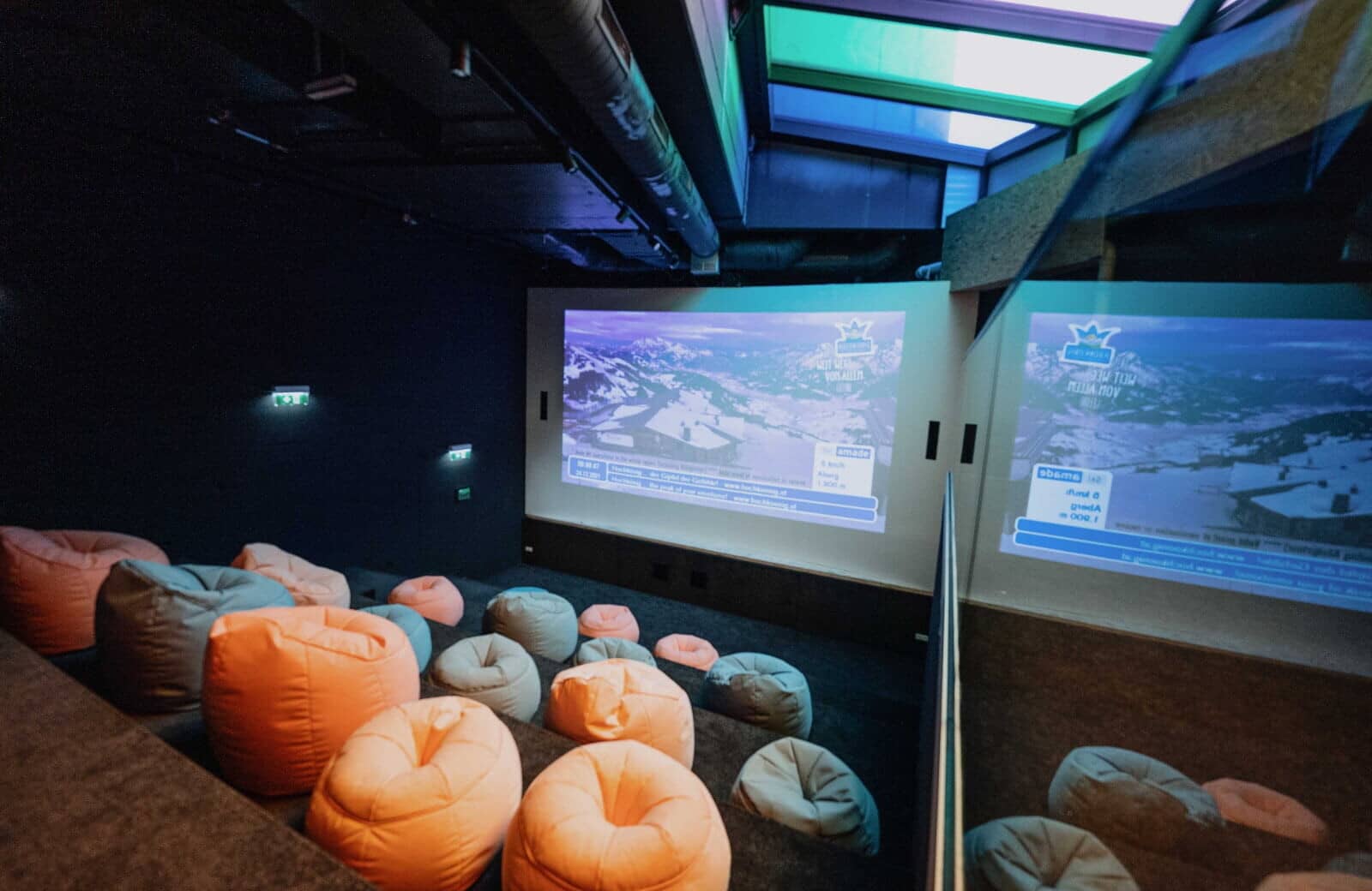 Private cinema room with beanbag seating and projector screen