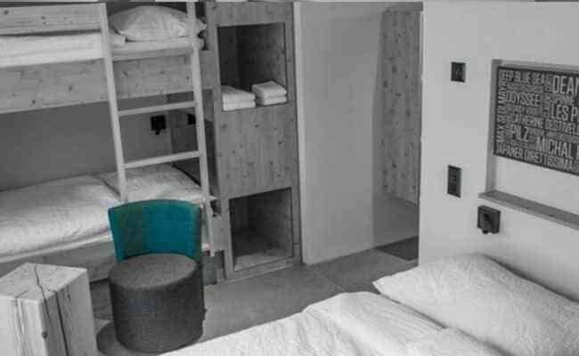 Bunk room with built-in storage cubbies and bedside reading lights