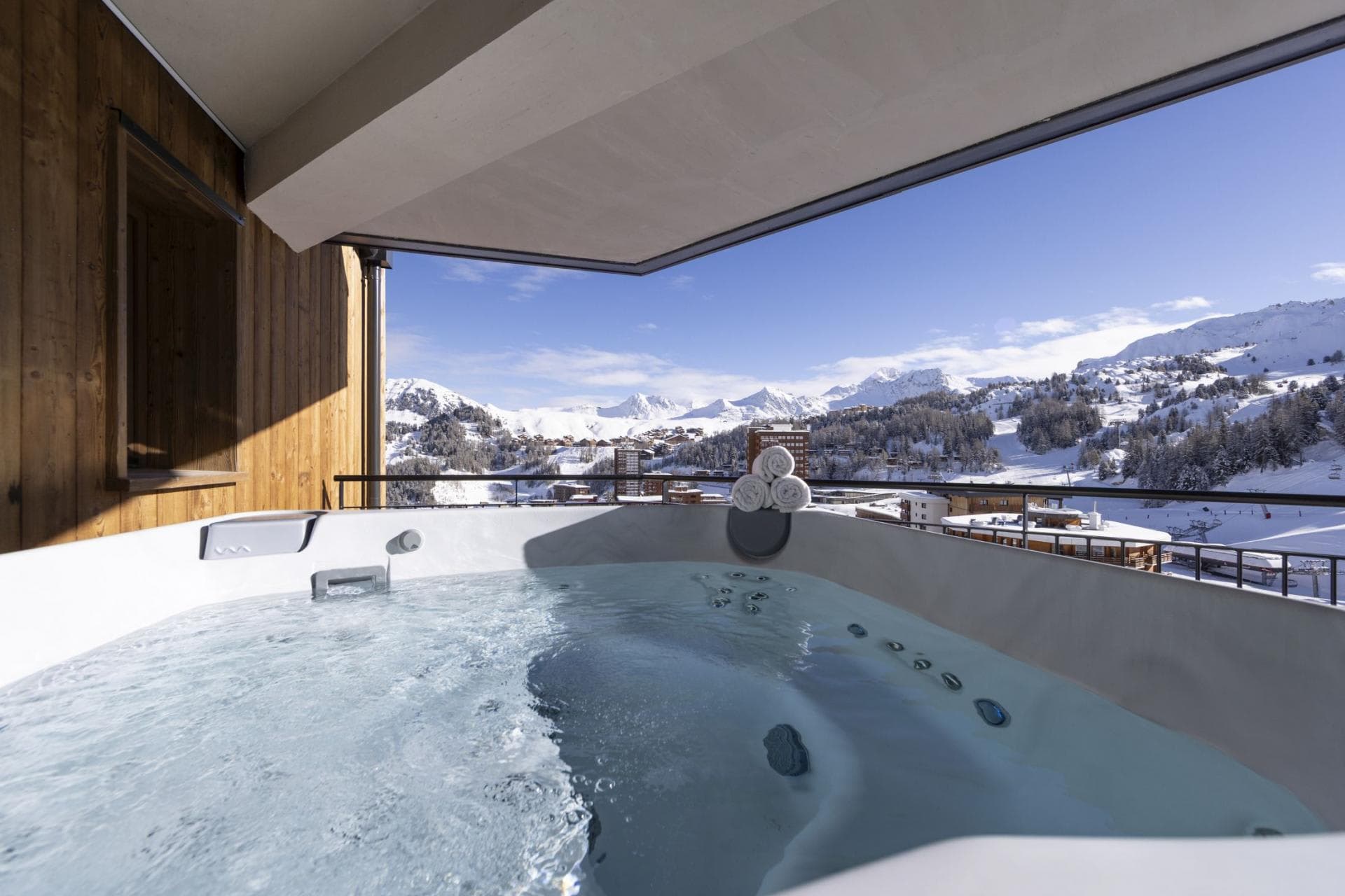 Private balcony hot tub with panoramic Alpine and ski resort views