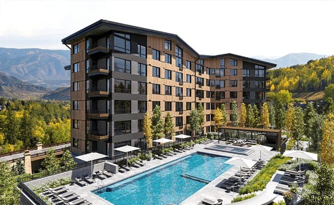 Shared outdoor pool and hot tub with mountain valley views