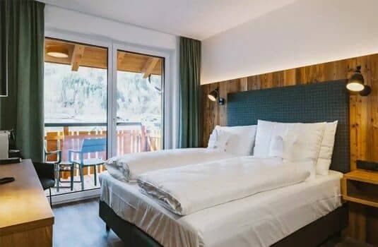 Bedroom with two twin beds and private balcony access