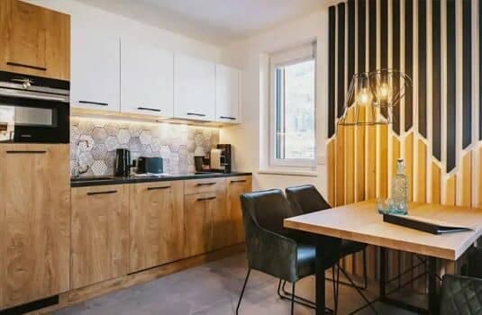 Kitchen with built-in microwave and dining table for four