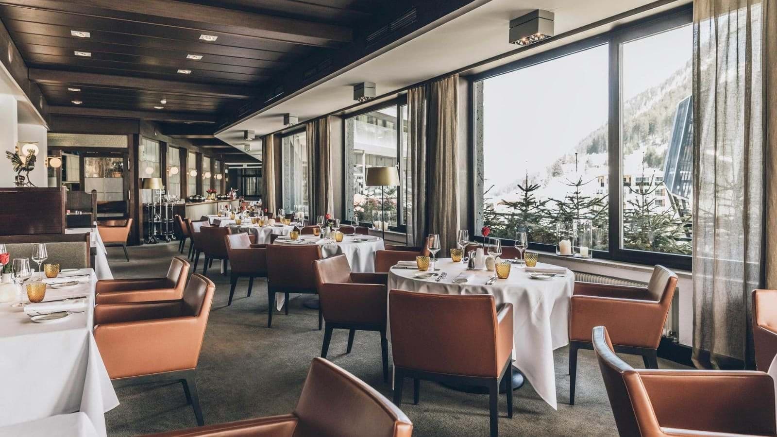 Dining room with mountain views and leather armchair seating