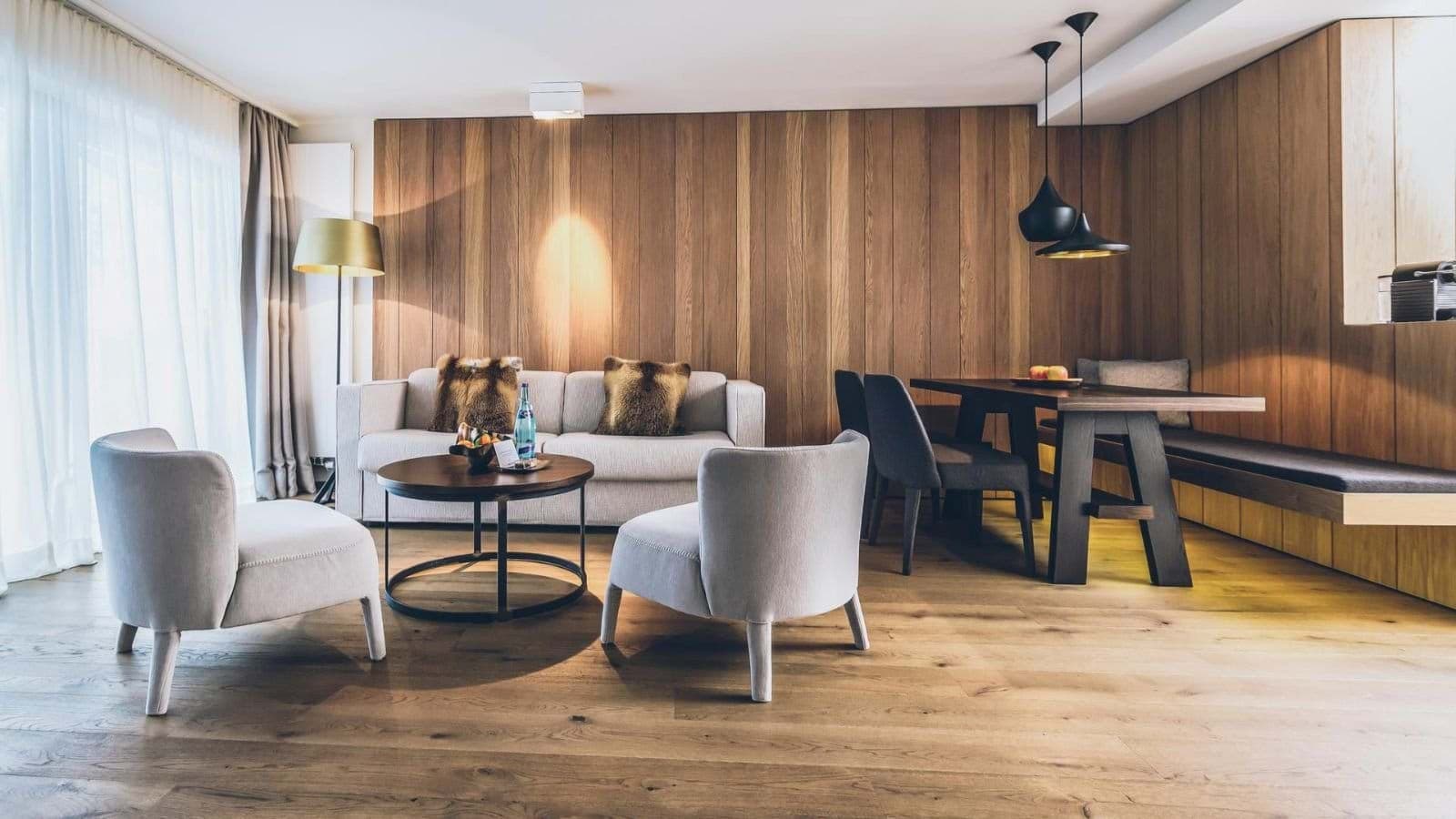 Open-plan living area with oak paneling and dining seating for 6