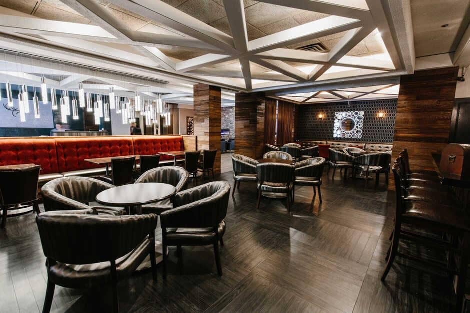 Lounge area with tufted banquet seating and round club chairs