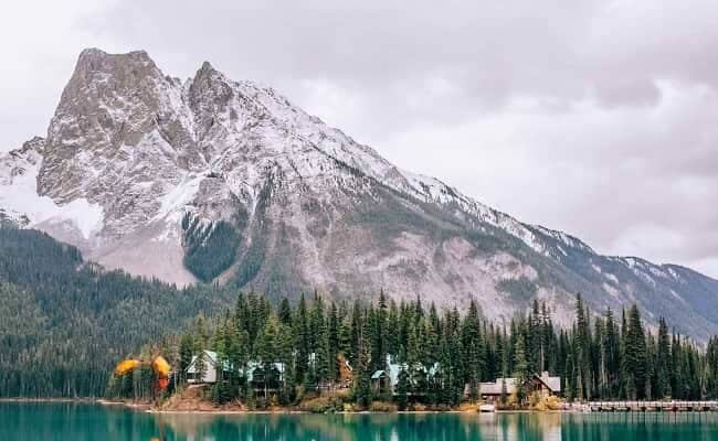 Lakeside cabins with turquoise glacial water and mountain backdrop