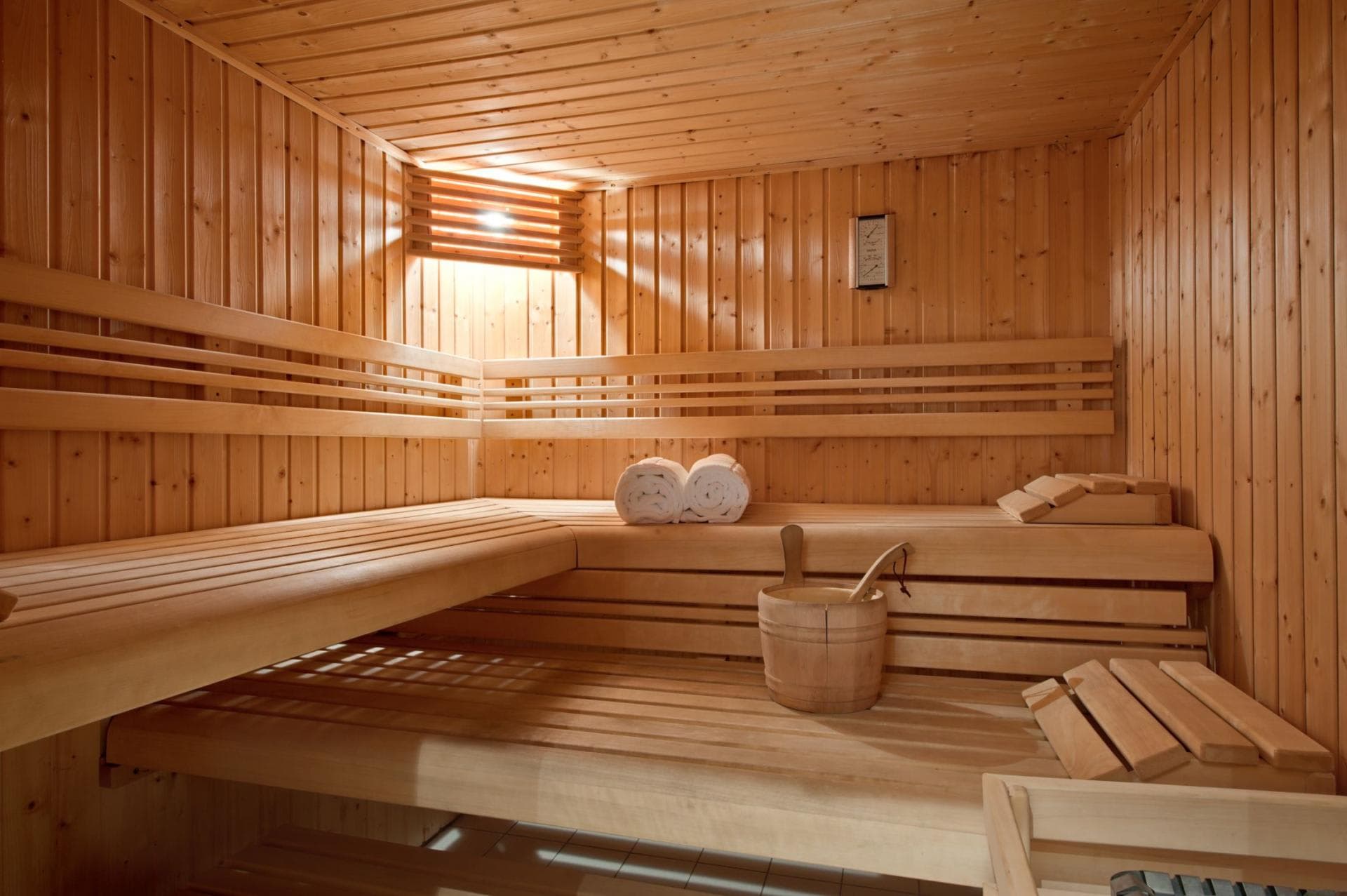 Cedar wood sauna with two-tier seating and integrated headrests