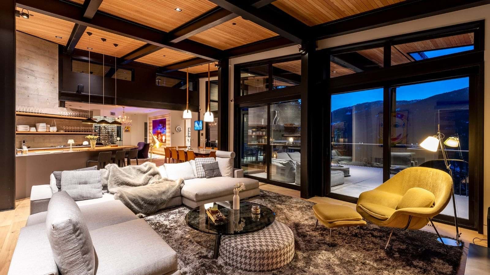 Open-plan living area with floor-to-ceiling windows and mountain views