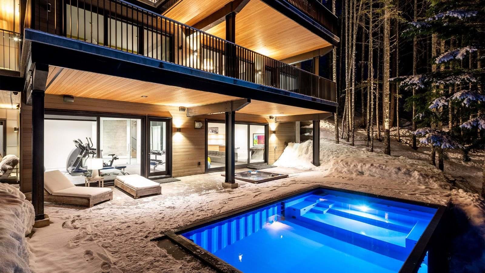 Lower deck with heated pool, hot tub, and adjacent fitness center