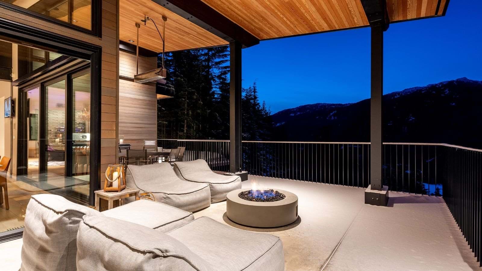 Covered deck with fire pit, lounge seating, and overhead heaters