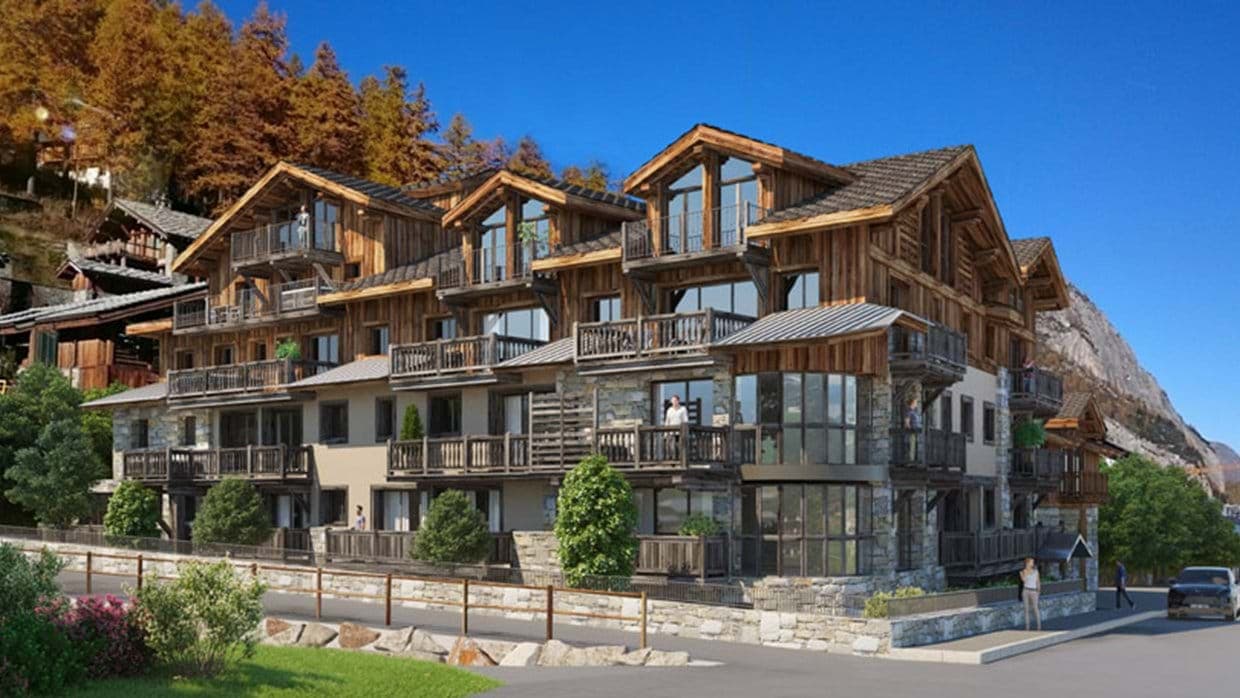 Chalet exterior featuring private balconies and stone-and-timber construction
