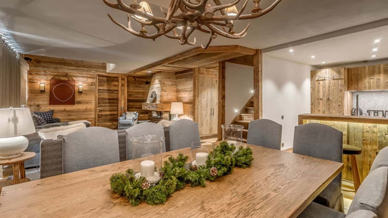 Dining area with antler chandelier and reclaimed wood walls