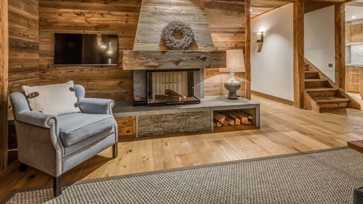 Living area with wood-burning fireplace and wall-mounted TV