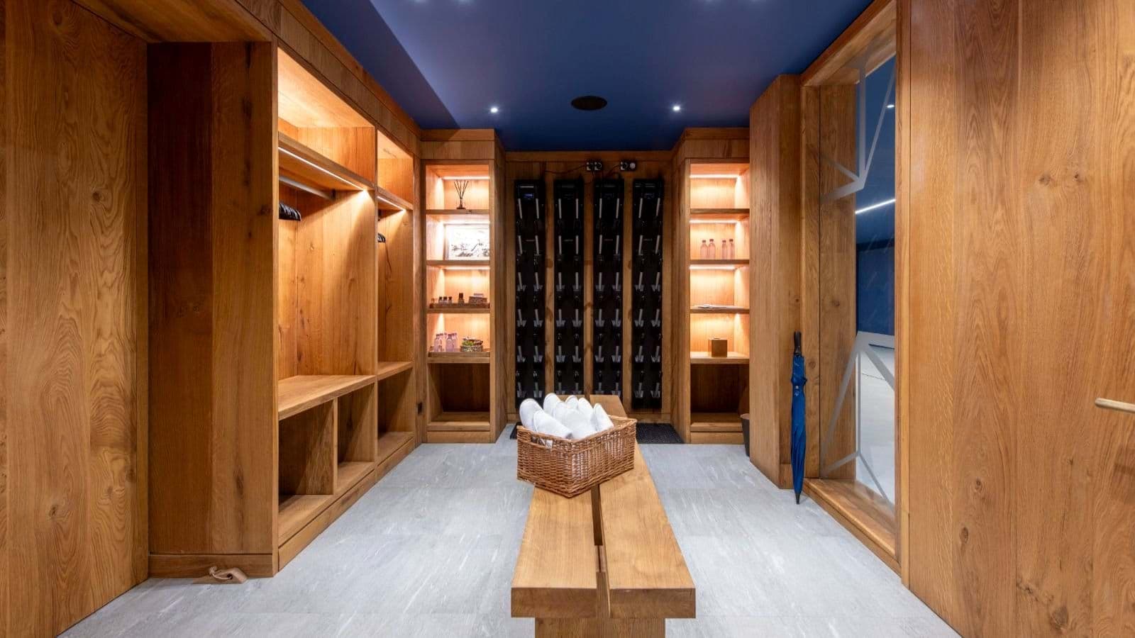 Ski room with heated boot racks and custom wood storage