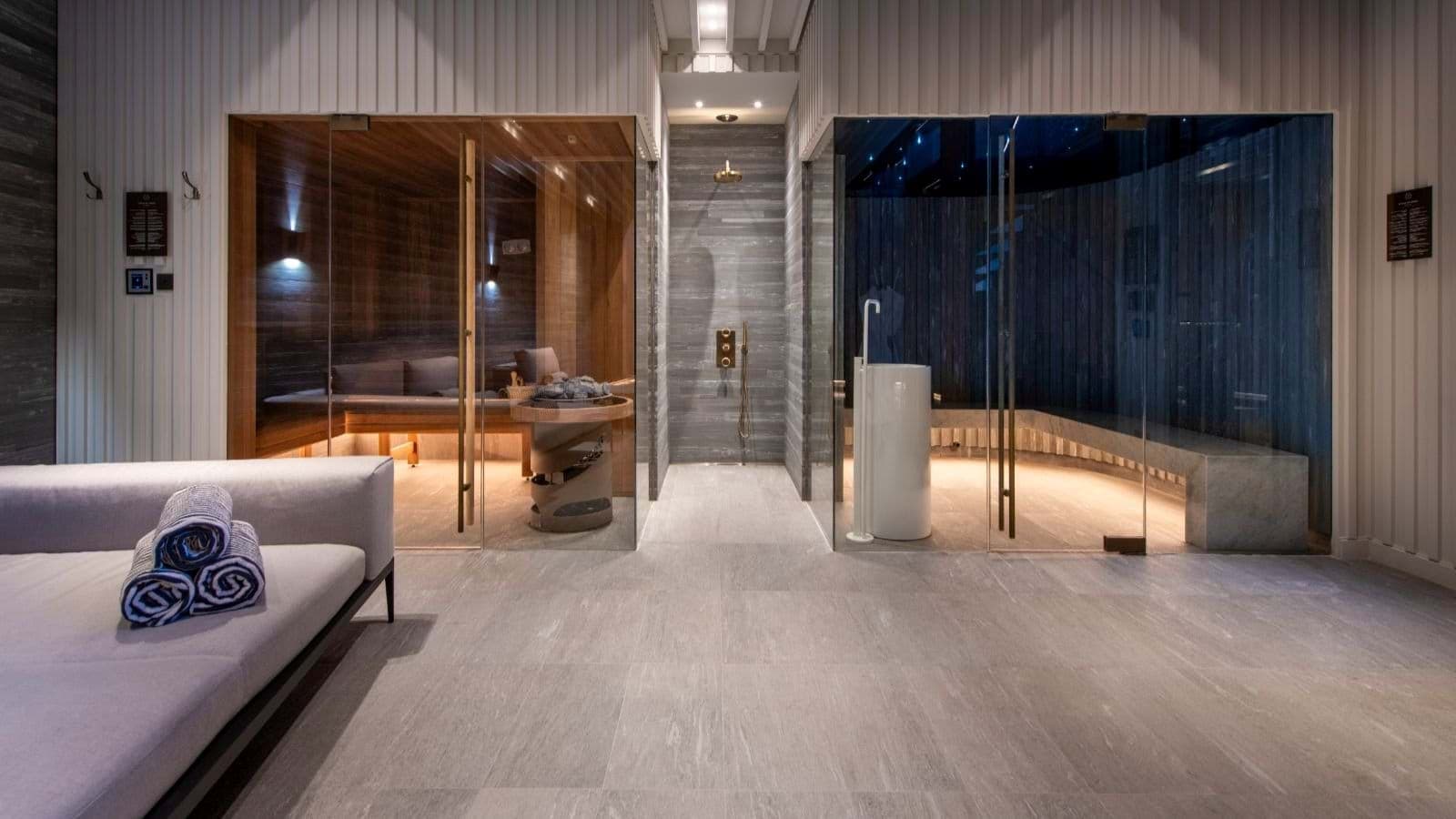 Spa area with dry sauna, steam room, and walk-in rainfall shower