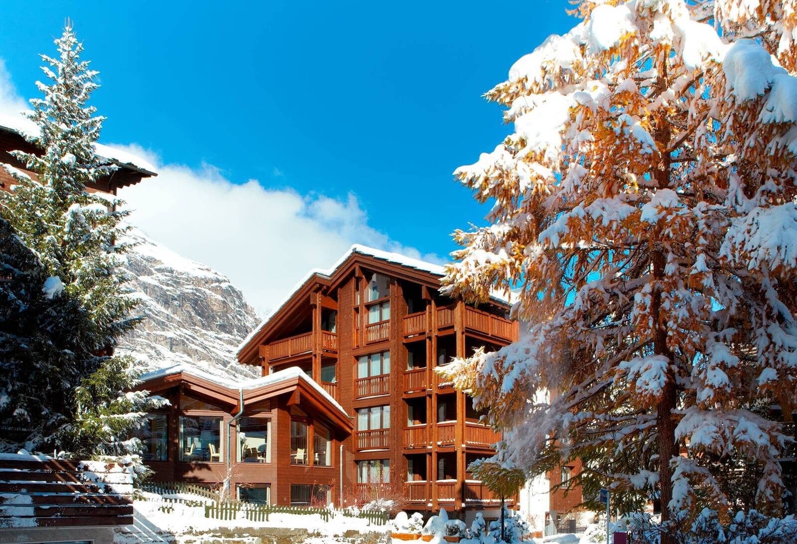 Timber chalet exterior with private balconies and mountain views