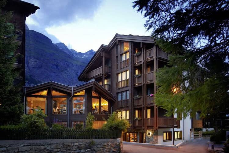 Chalet exterior featuring private balconies and mountain views