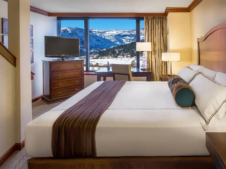 Primary bedroom with king bed, dedicated workspace, and mountain views