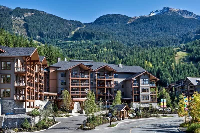 Ski-in/ski-out lodge exterior with private balconies and mountain backdrop