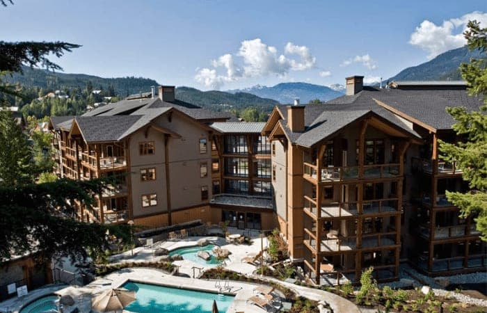 Resort exterior with heated outdoor pools and mountain views