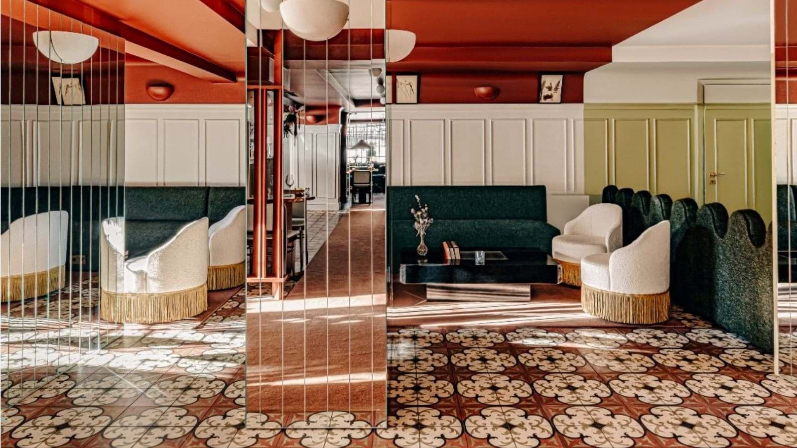 Lounge area with mid-century seating and patterned tile flooring