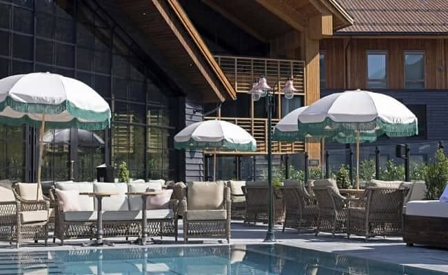 Poolside terrace with fringe umbrellas and lounge seating for large groups