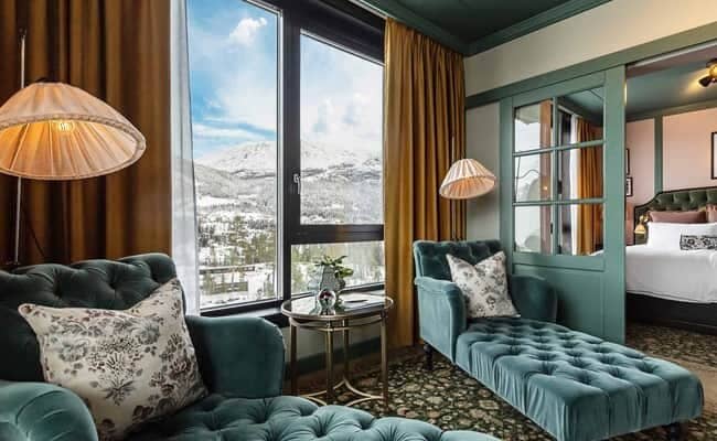 Sitting area with chaise lounges and views of the snow-covered mountains