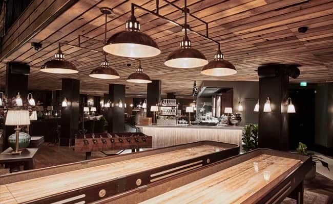 Game room with shuffleboard, foosball, and full bar service