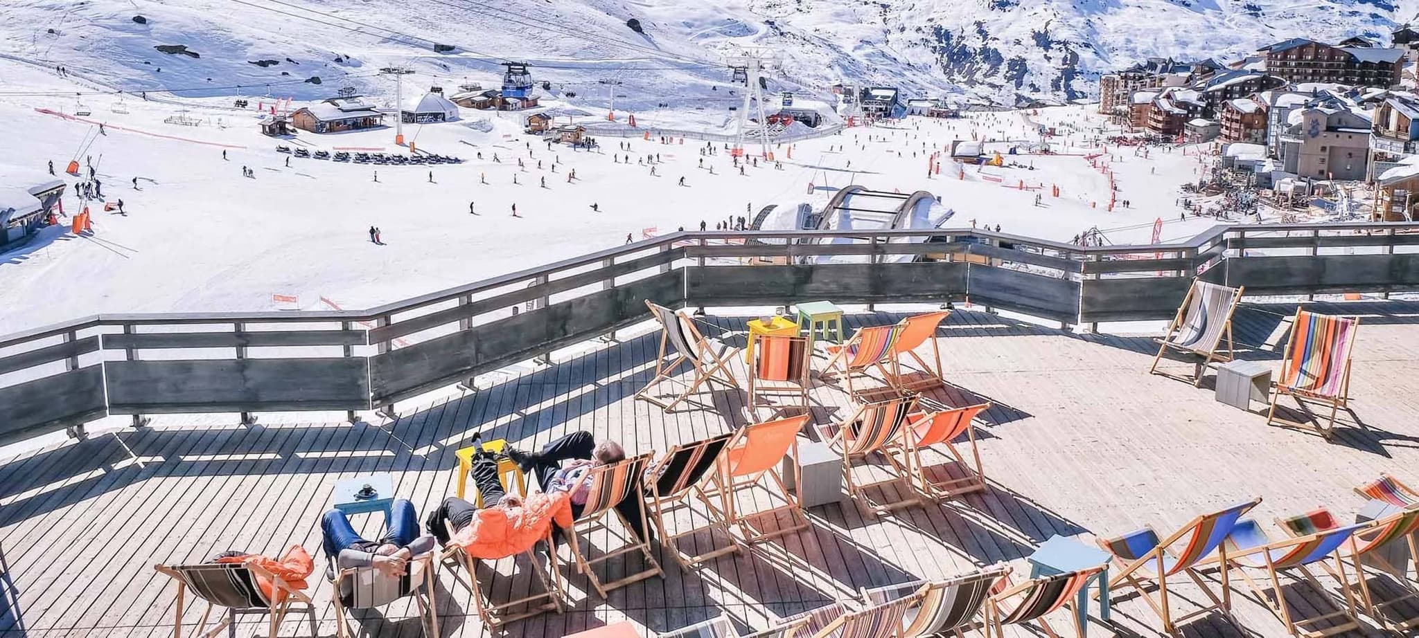 Sun deck with lounge chairs overlooking the ski resort slopes