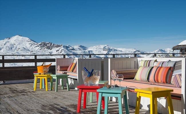 Outdoor deck with built-in seating and alpine mountain views